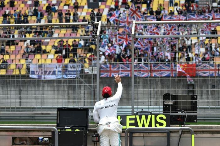 World champion Lewis Hamilton waves to fans at the Chinese Grand Prix in Shanghai last year, but this year's race is under threat from the deadly virus sweeping China