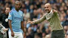 Manchester City manager Pep Guardiola gives instructions to Fernandinho