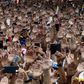 People raise their hands during a mass opposition rally against President Nicolas Maduro on January 23, 2019, after National Assembly head Juan Guaido declared himself the country's 'acting president'
