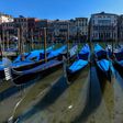 Gondolas sit empty in Venice's Grand Canal with Italy in lockdown to confront the dire impact of new coronavirus which, in one day, killed 475 more people in the country