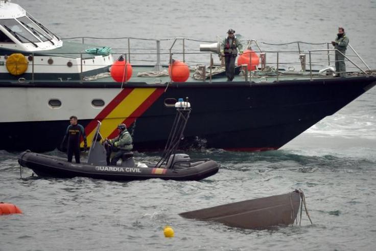 The prow of a submarine used to transport drugs illegally emerges as Spanish Guardia Civil's divers work to refloat it in northwestern Spain