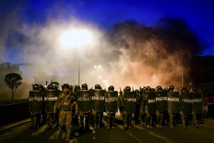 Bolivian police take position as supporters of Bolivian ex-President Evo Morales block a road in the outskirts of Sacaba, Chapare province, Cochabamba