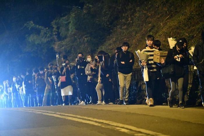 Mourners arrive to pay their respects at a memorial service for Hong Kong student Alex Chow, 22