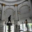 A sweeper cleans the floor of the General Post Office in Kolkata after some lockdown restrictions were relaxed