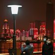 People wearing facemasks walk near the Yangtze River in Wuhan, epicentre of the coronavirus, which reported no new deaths from the disease for the first time since January