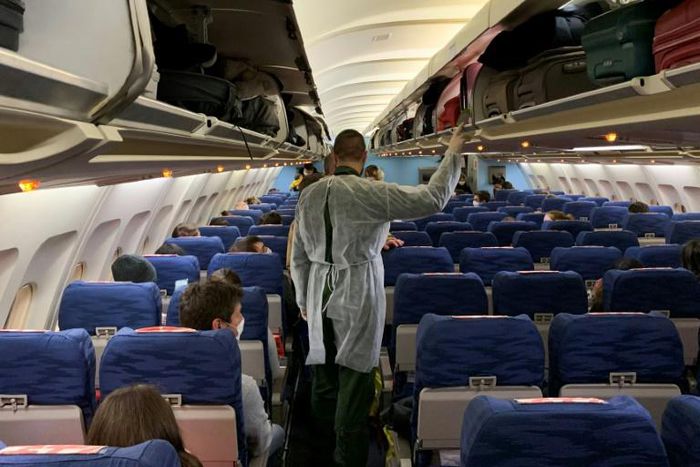 French citizens board an evacuation plane in Wuhan on Thursday night