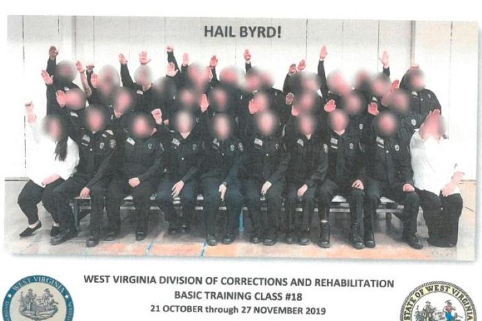 An investigation concluded that "ignorance" and an "appalling lack of judgment" motivated the Nazi salute in this group photo showing apprentice prison officers in West Virginia