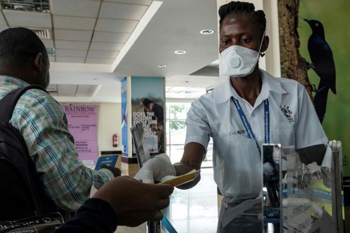 Entebbe airport health workers checked travel documents of passengers arriving on an international flights