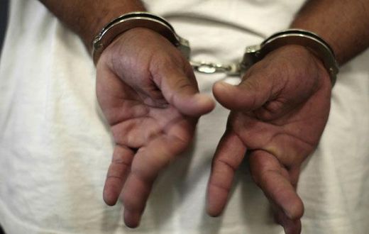 A woman in handcuffs