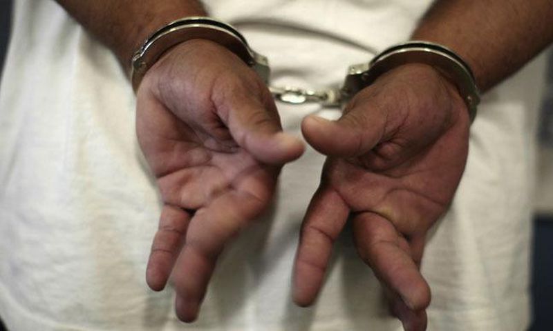 A woman in handcuffs