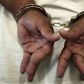 A woman in handcuffs