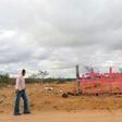 A woman walks near pink crosses placed in memory of eight murdered women at Lomas de Poleo, in Ciudad Juarez -- once dubbed the "murder capital of the world"
