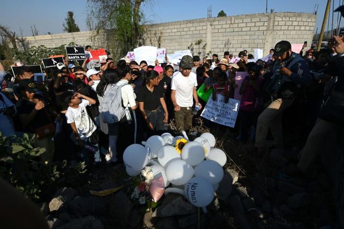 People lay white balloons and flowers at the site where the body of a seven-year-old girl was found over the weekend with signs of torture in  Mexico City
