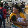 Honduran migrants wait to cross the international border bridge from Ciudad Tecun Uman in Guatemala to Ciudad Hidalgo in Mexico in January 2020