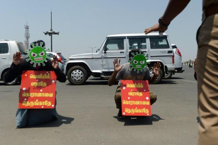People who ignored the lockdown in Chennai were forced by police to don masks and placards reading "Don't come out, don't go near to corona" as punishment