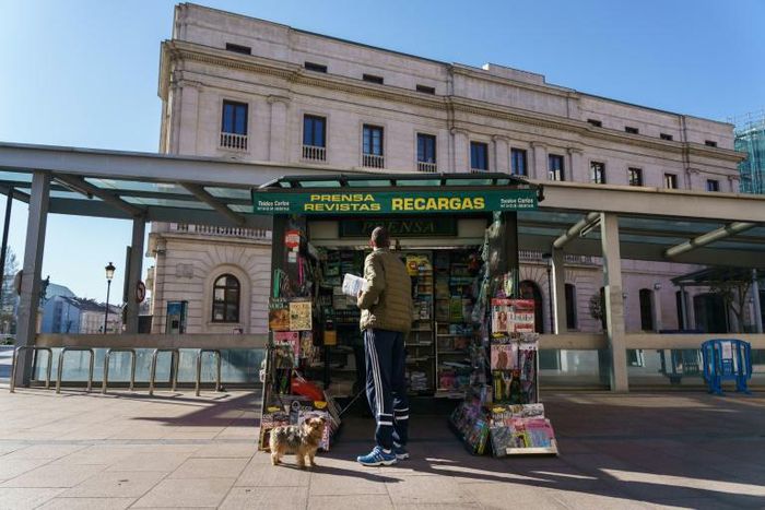 A man uses the chance to stretch his legs by walking his dog in the central northern town of Burgos -- one of the few means of beating Spain's coronavirus lockdown