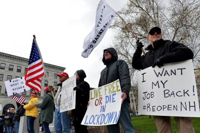 Hundreds of New Hampshire residents rallied outside the statehouse in Concord on April 18 to urge a quick end to the northeastern state's virus-related stay-at-home rule