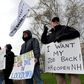 Hundreds of New Hampshire residents rallied outside the statehouse in Concord on April 18 to urge a quick end to the northeastern state's virus-related stay-at-home rule