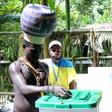 Young Upe men cast their votes in the Bougainville Referendum at the men's only polling station in Teau Bougainville, Papua New Guinea.