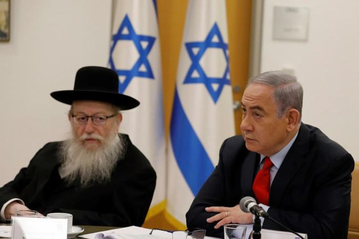Israeli Prime Minister Benjamin Netayahu (R) and Health Minister Yaakov Litzman hold a video conference with European leaders on the COVID-19 coronavirus on March 9
