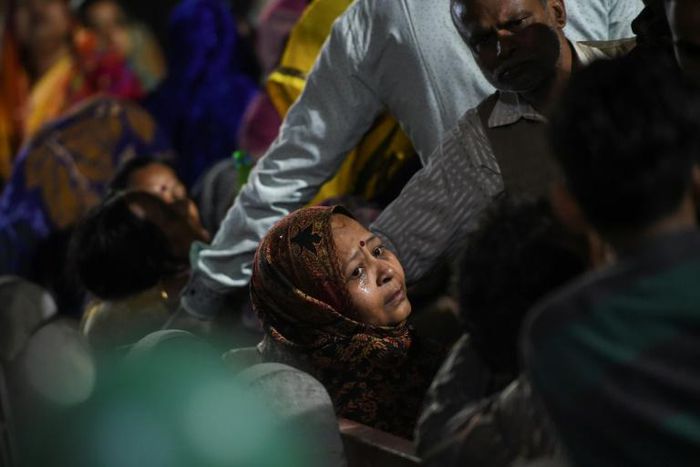A relative of Rahul Thakur, 23, who died in this week's sectarian riots in India's capital, mourns before his cremation