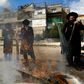 Jewish men burn food with leavening agents ahead of the start of Passover, in the the ultra-Orthodox Mea Shearim neighbourhood of Jerusalem