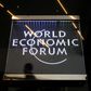A man walks past a sign of the World Economic Forum (WEF) at the Congress Centre in Davos, eastern Switzerland