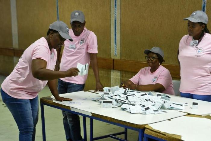 Polling officers verify ballots at a counting centre in the Ledumang Senior Secondary school for the Gaborone North constituency, in Gaborone on October 23, 2019