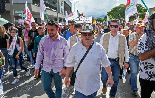 Rodrigo Londono aka Timochenko (C), seen here taking part in a general strike against the government Colombian President Ivan Duque in Medellin in November