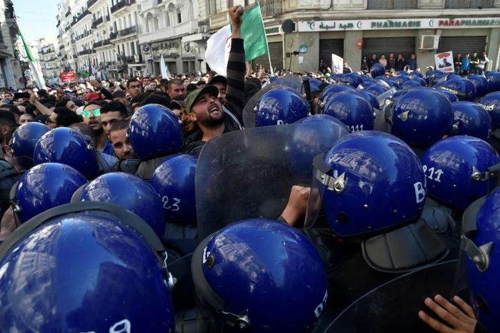 Algerian riot police block the progress of an anti-government demonstration heading towards the presidential palace in the capital Algiers, on Saturday