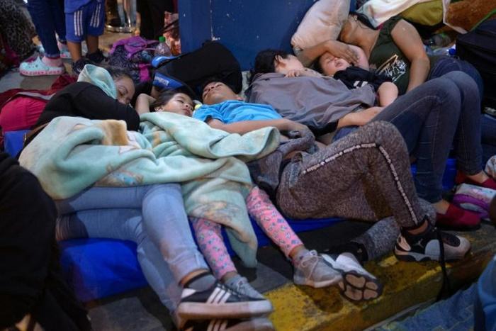 Venezuelan migrants wait to get a refugee application at a Peruvian border post in June 14 2019: the US Treasury has accused the head of a Venezuela government agency of seeling off passports for bribes