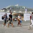 Tourists disembark at Doha Port's temporary passenger terminal