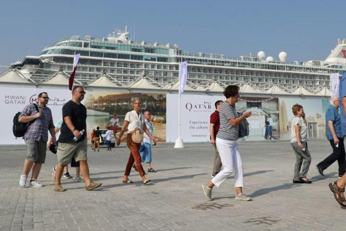 Tourists disembark at Doha Port's temporary passenger terminal