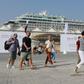 Tourists disembark at Doha Port's temporary passenger terminal
