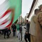 An Algerian protester waves the national flag during a weekly anti-government demonstration in the capital Algiers on March 13 before the rallies were suspended because of the novel coronavirus