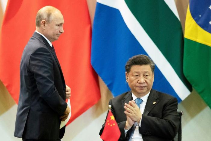 China's President Xi Jinping (R) and Russia's President Vladimir Putin, pictured November 2019, spoke after the US criticised China for not sharing information on the virus more quickly