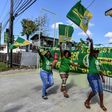 Supporters of presidential candidate David Granger, of the National Unity and Alliance for Change (APNU+AFC) party, cheer and wave flags in Georgetown ahead of Monday's elections in Guyana