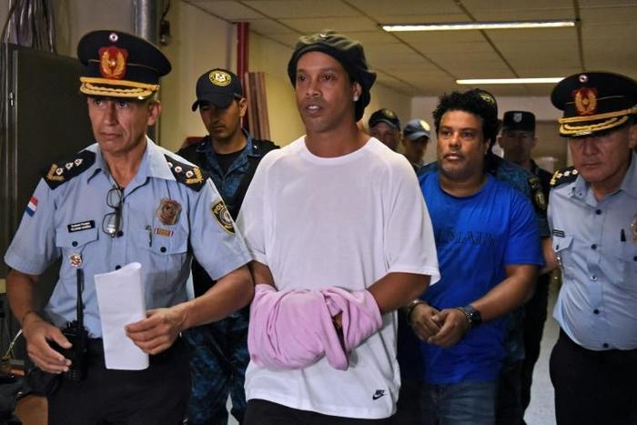 Retired Brazilian football star Ronaldinho (C) and his brother Roberto Assis were sent to jail in early March 2020 to await trial on charges of using false passports to enter Paraguay