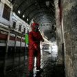 A Red Crescent member sprays disinfectant along an alley of the historic Hamidiya souk (market) in the old city of Syria's capital Damascus as part of efforts against the coronavirus pandemic