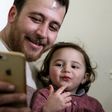 Syrian father Abdullah al-Mohammed with his three-year-old daughter Salwa. A video in which she laughs every time an explosion goes off was widely shared on social media as a heartening but grim reminder of Idlib residents' daily lives