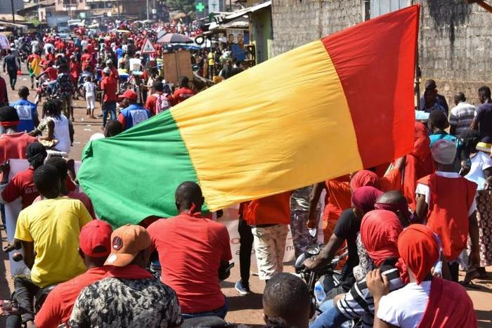 Demonstrators take part in a protest against the third term of Guinean President Alpha Conde, in Conakry, on November 26
