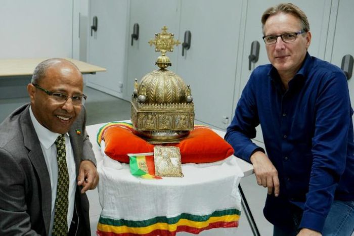 Dutch-Ethiopian Sirak Asfaw, left, and art detective Arthur Brand pose with the crown at a high-security facility in the Netherlands in September last year