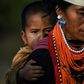 A Naga tribeswoman carrying a child at the end of an overnight ceremony to bless the harvest in Satpalaw Shaung village in Myanmar's Sagaing region
