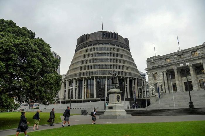 New Zealand's finance minister Grant Robertson has likened the government's virus response to a defensive tackle from the country's famous All Blacks