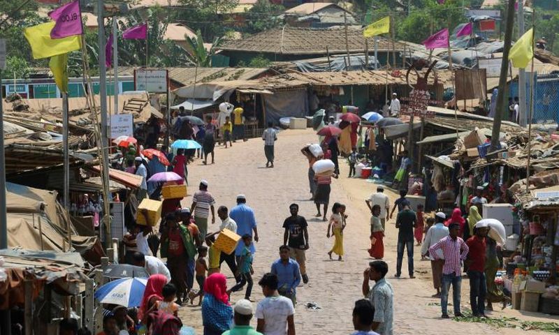 Rohingya refugees gather in a market area of the Kutupalong refugee camp in Bangladesh on March 24, 2020 -- "social distancing" to protect against the coronavirus pandemic is "virtually impossible", an NGO said