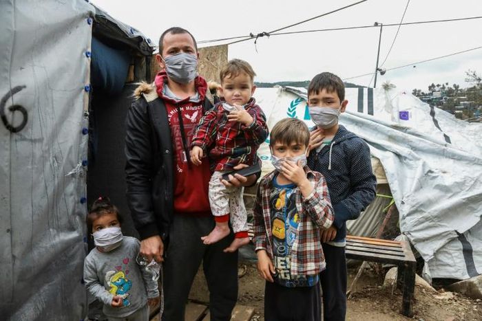 A migrant family wearing handmade protective face masks in the camp of Moria on the Greek island of Lesbos