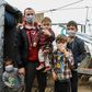 A migrant family wearing handmade protective face masks in the camp of Moria on the Greek island of Lesbos