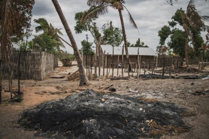 A mound of ashes is seen in the recently attacked village of Aldeia da Paz outside Macomia, Mozambique, on August 24, 2019