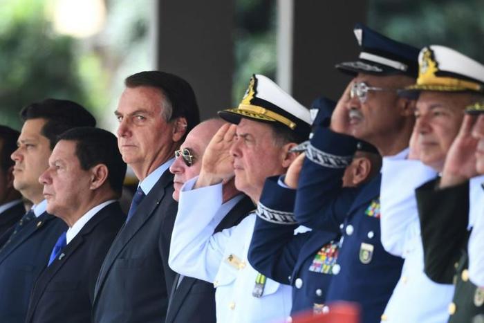 Brazil's President Jair Bolsonaro (third from left) is accelerating plans to open up protected indigenous land to economic activities