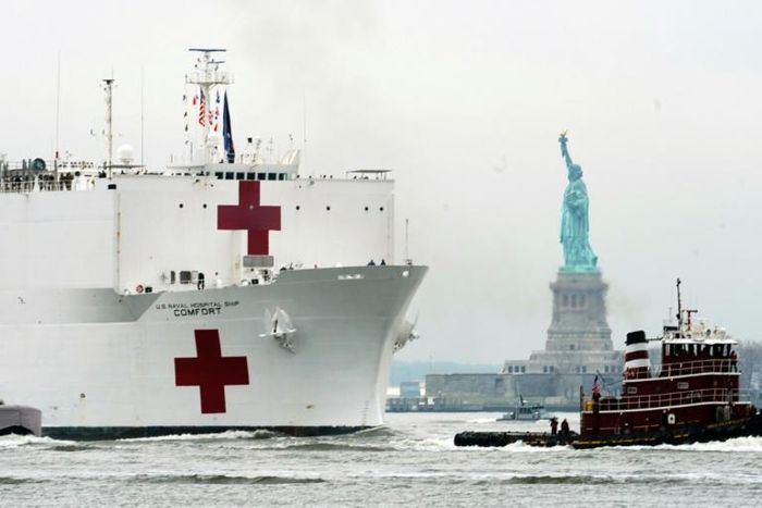The USNS Comfort medical ship moves up the Hudson River past the Statue of Liberty as it arrives on March 30, 2020 in New York